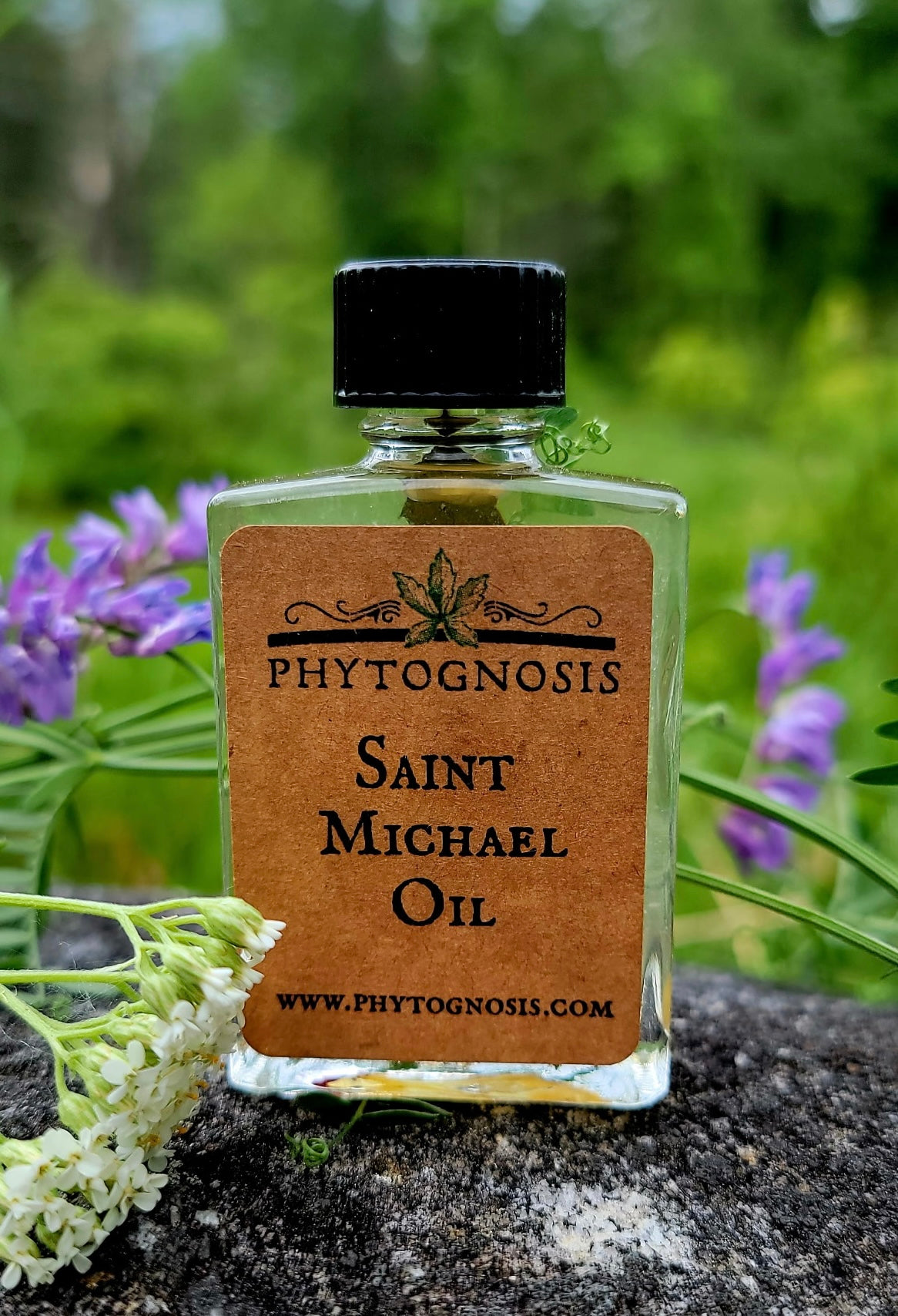 Bottle of Saint Michael Oil by Phytognosis with a natural background