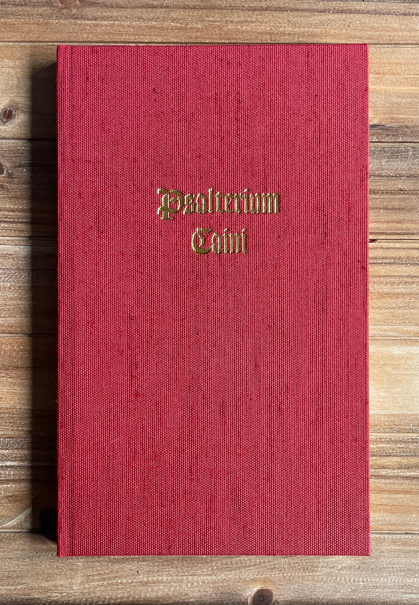 The Psalter of Cain hardcover edition, full red linen binding with gilt blocking and serpentine-embossed endsheets