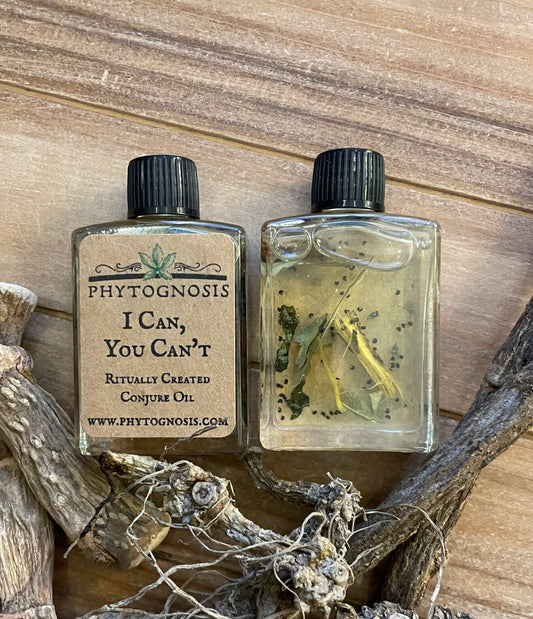 Two bottles of Phytognosis oil with herbs on a wooden surface 