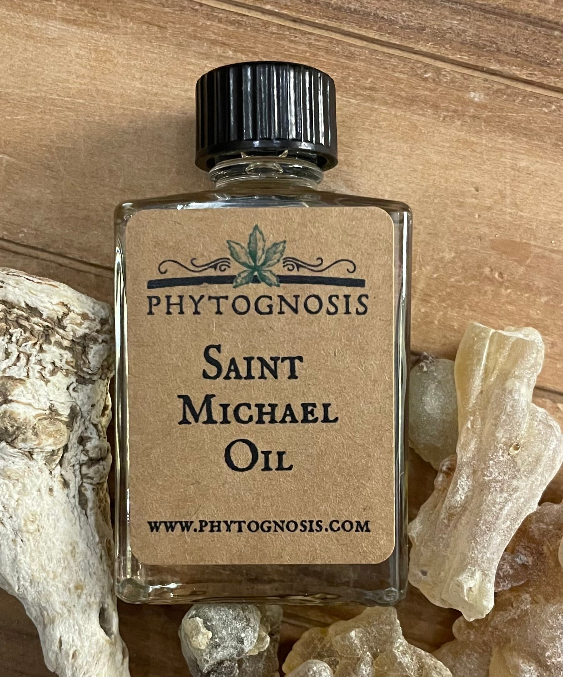 Bottle of Saint Michael Oil by Phytognosis on a wooden surface with roots.